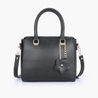 Black handbag with flower charm